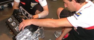 Aprilia mechanics with an RS3 Cube motorcycle engine