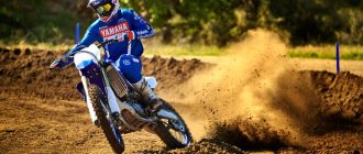 Rating of the best motocross motorcycles - in the picture, a man in a motocross racing uniform races on a section of a motocross track