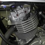 Rubber cap on the spark plug of a Suzuki GRASSTRACKER 250 motorcycle