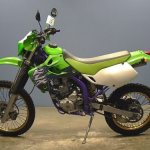 Side view of a Kawasaki KLX 250 motorcycle with green trim