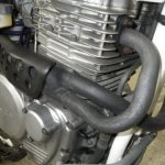 Exhaust manifold on a Honda XR650L motorcycle engine